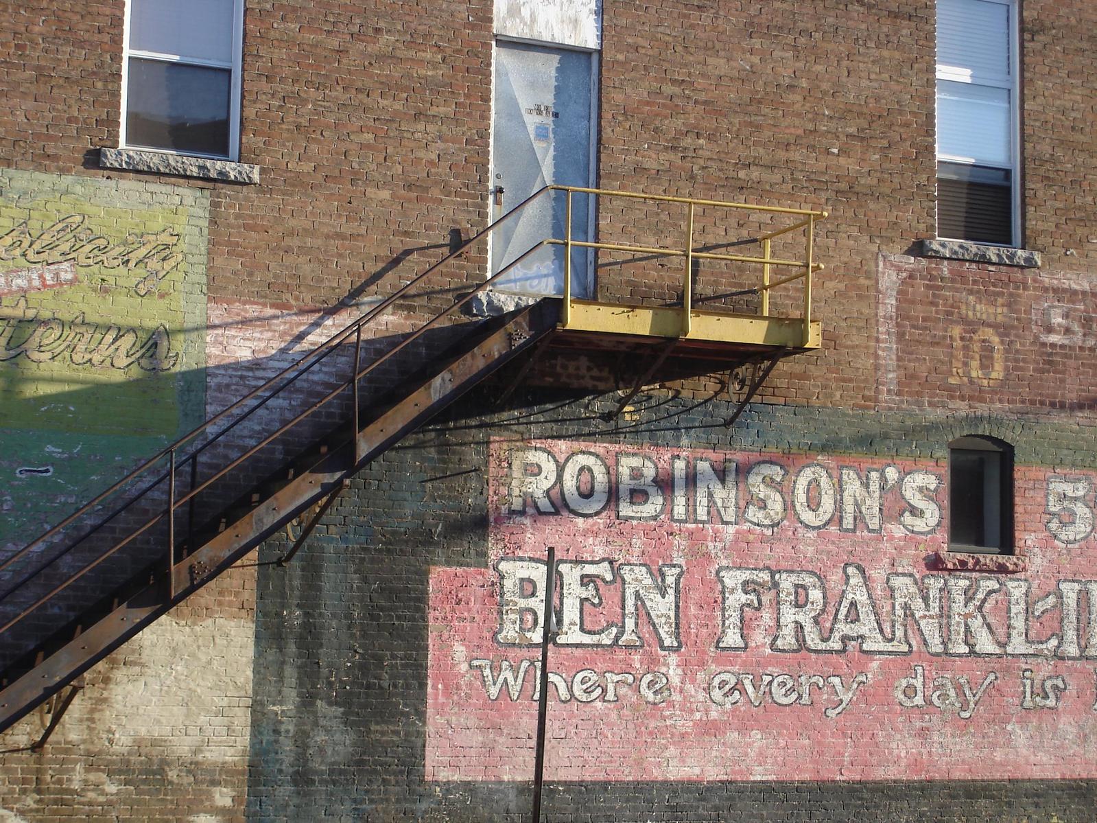 a building with a stair case and sign on the wall