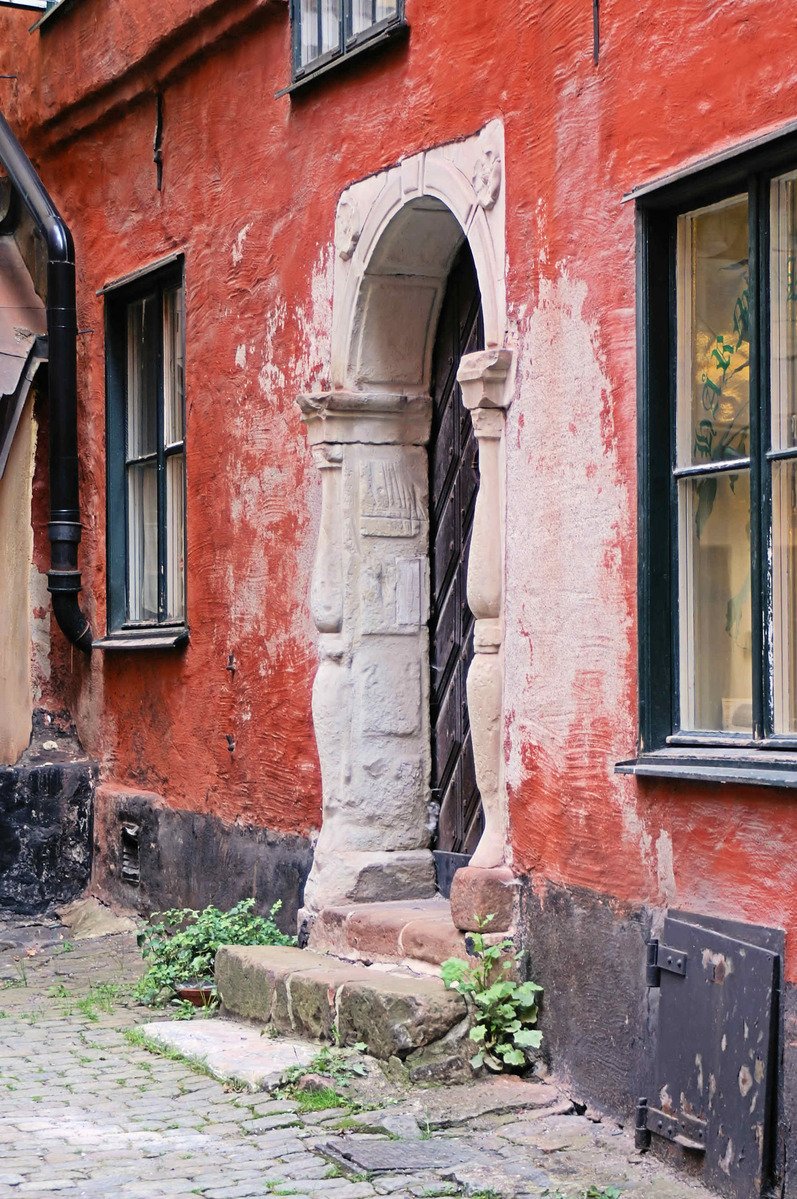 a view of the outside of a brick building with a door on it's sides