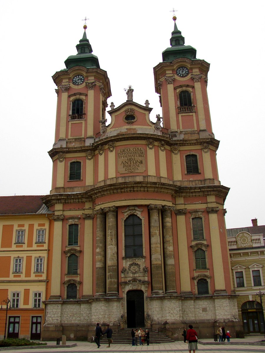 the cathedral at the entrance of a building with two towers