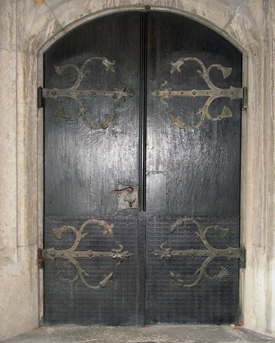 a large metal door has intricate patterns and designs on it