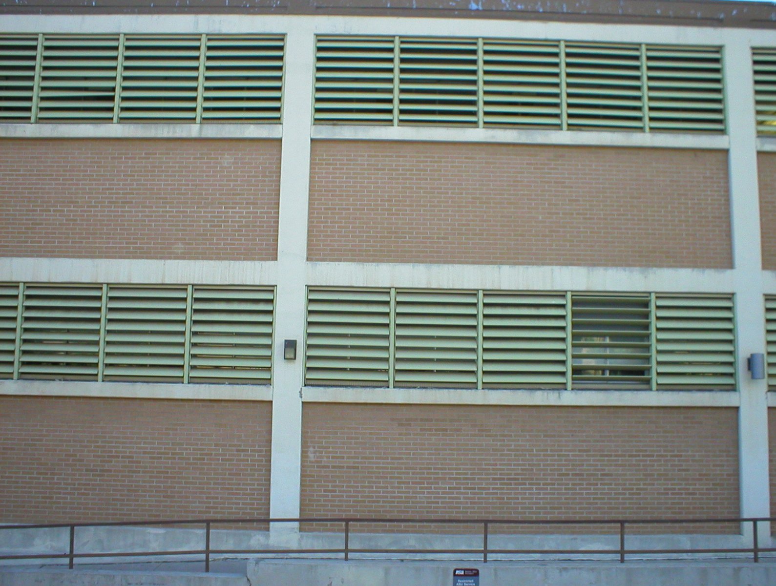 a large building with a parking sign on the side