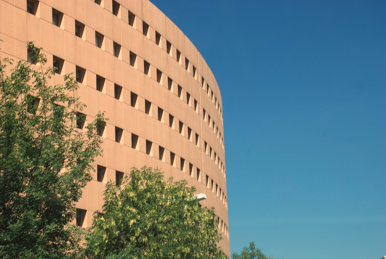 a tall building with holes in the side