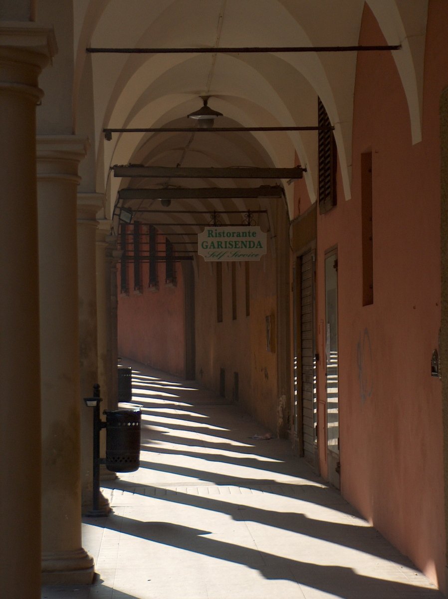 the sun is shining down on an old street