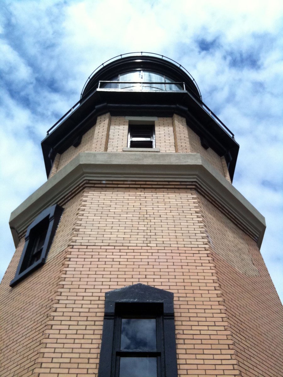 a tall brick building with a clock on the top of it