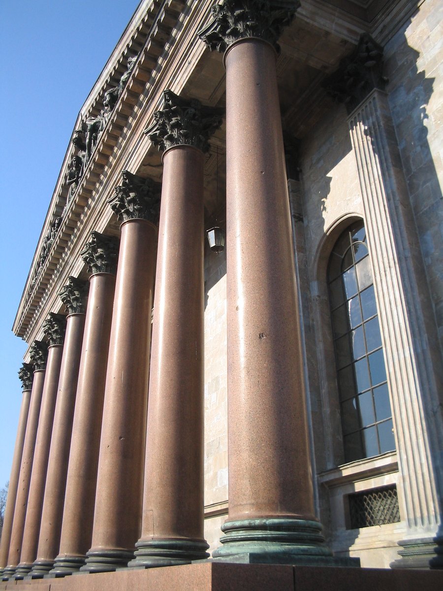 large stone building with ornate columns in front of it