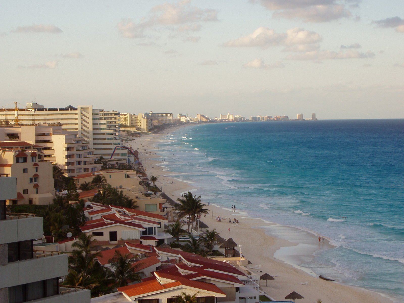 a beach lined with lots of tall buildings next to the ocean