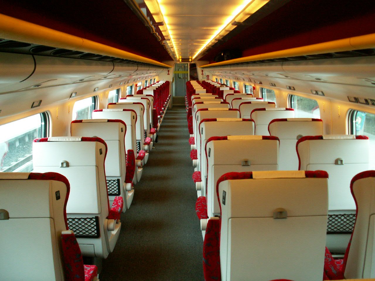 seats and desks in an empty train car