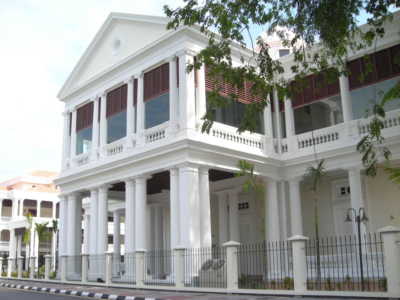 an old building is white with ornate columns