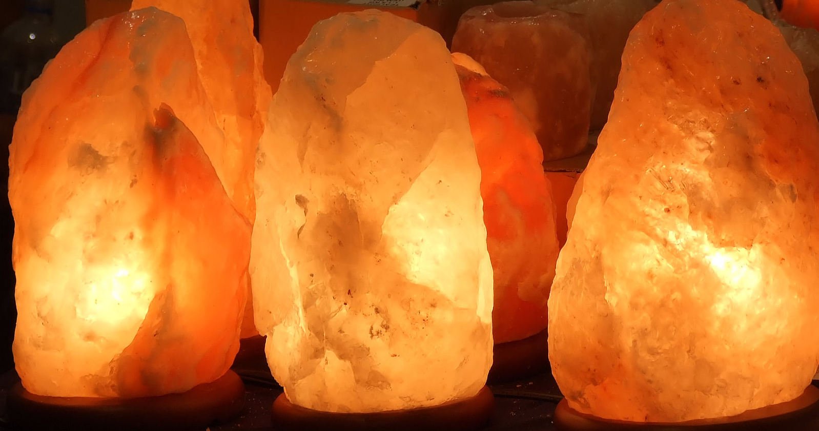 several orange crystalite lamps lit up in the dark