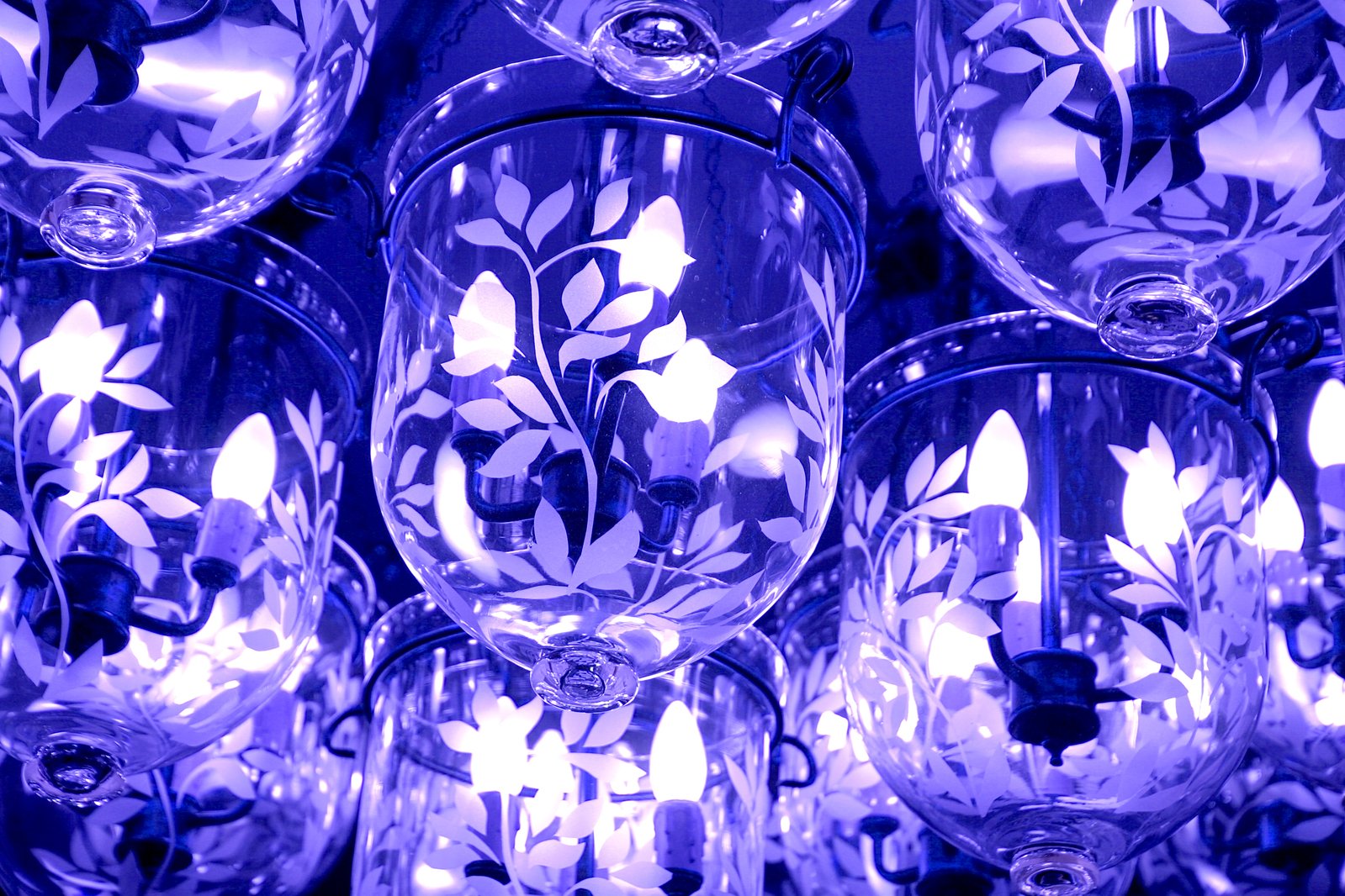 several blue wine glasses are arranged together