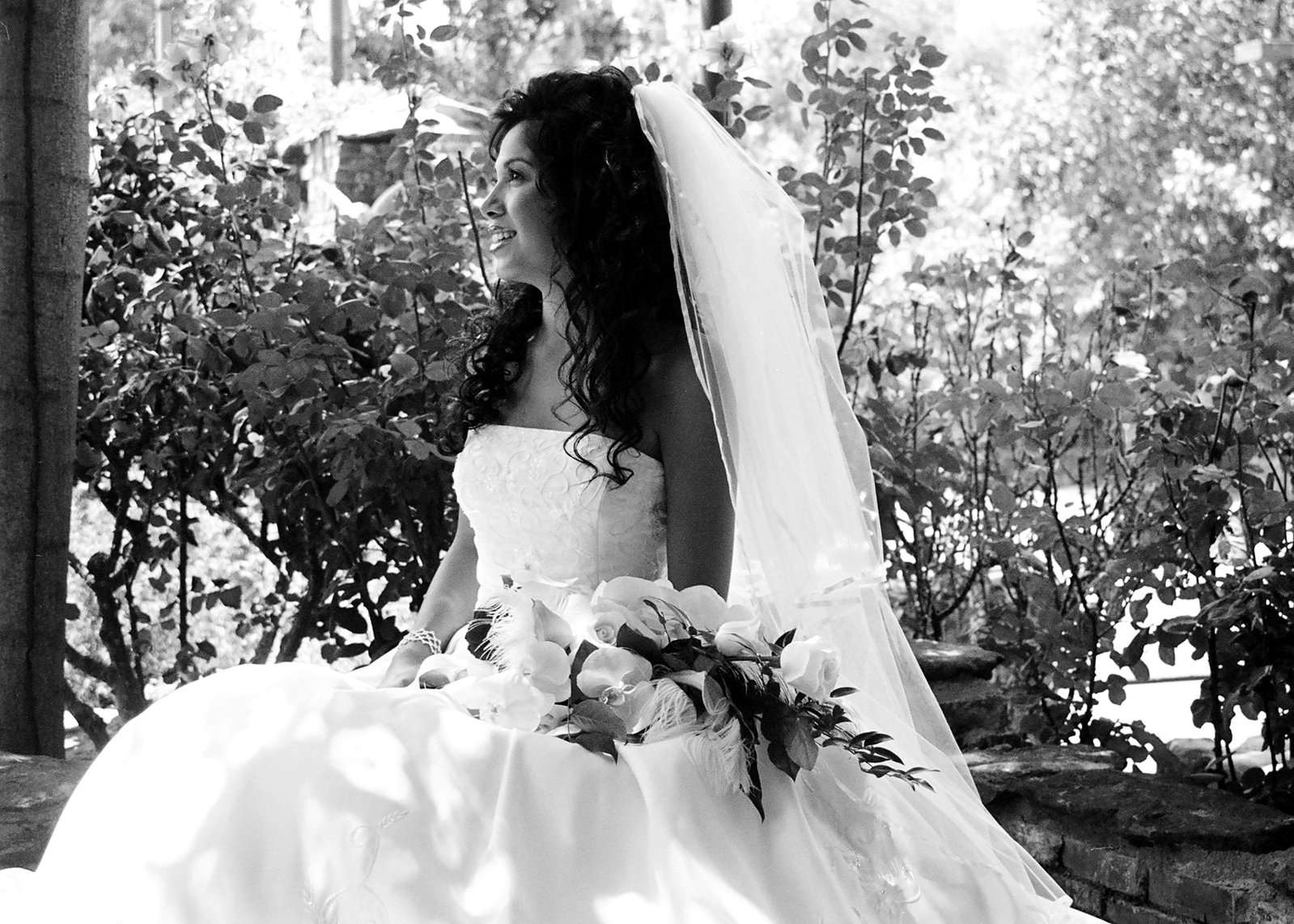 a woman dressed in white is sitting down and looking away