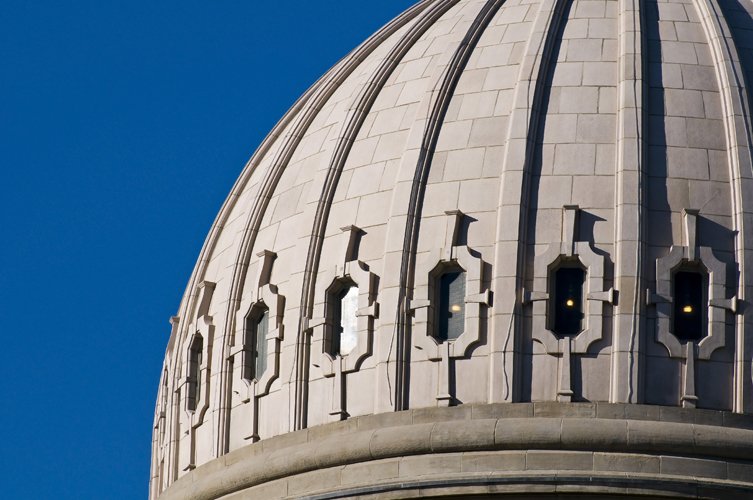 an architectural view of a dome and the moon in the sky