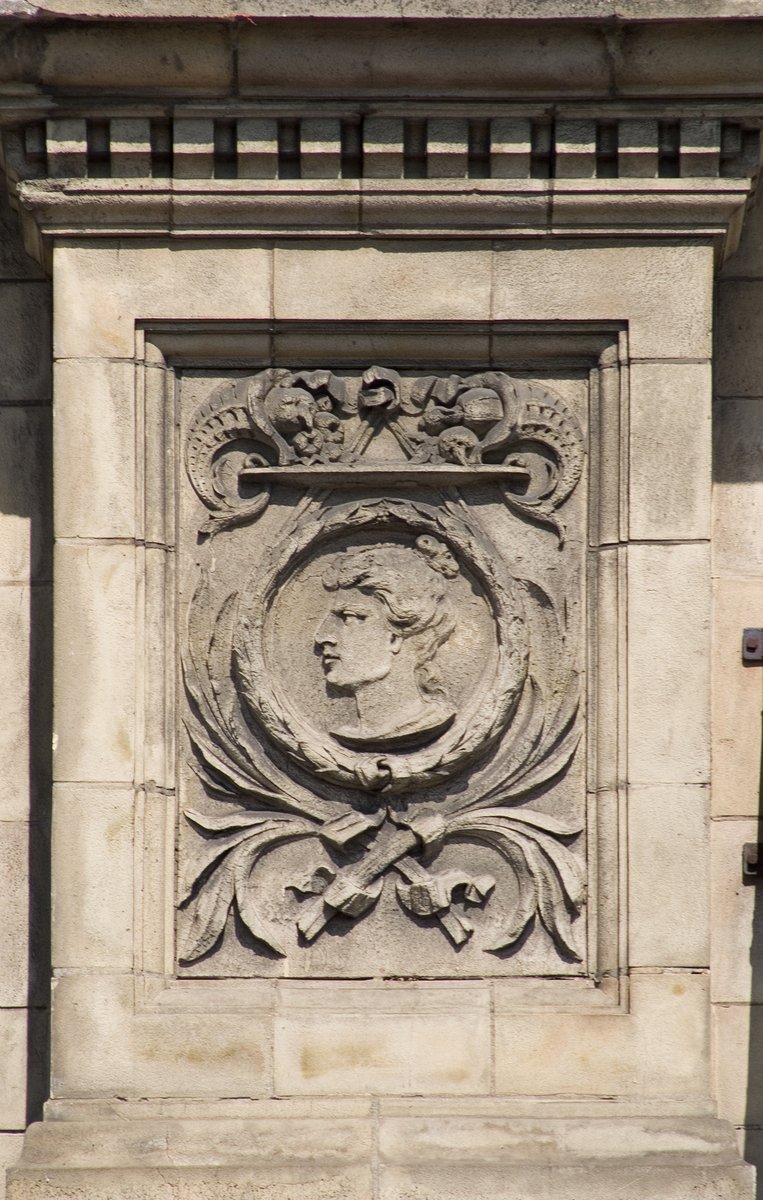 an antique design on the face of a man with a beard and a mustache is featured on a wall