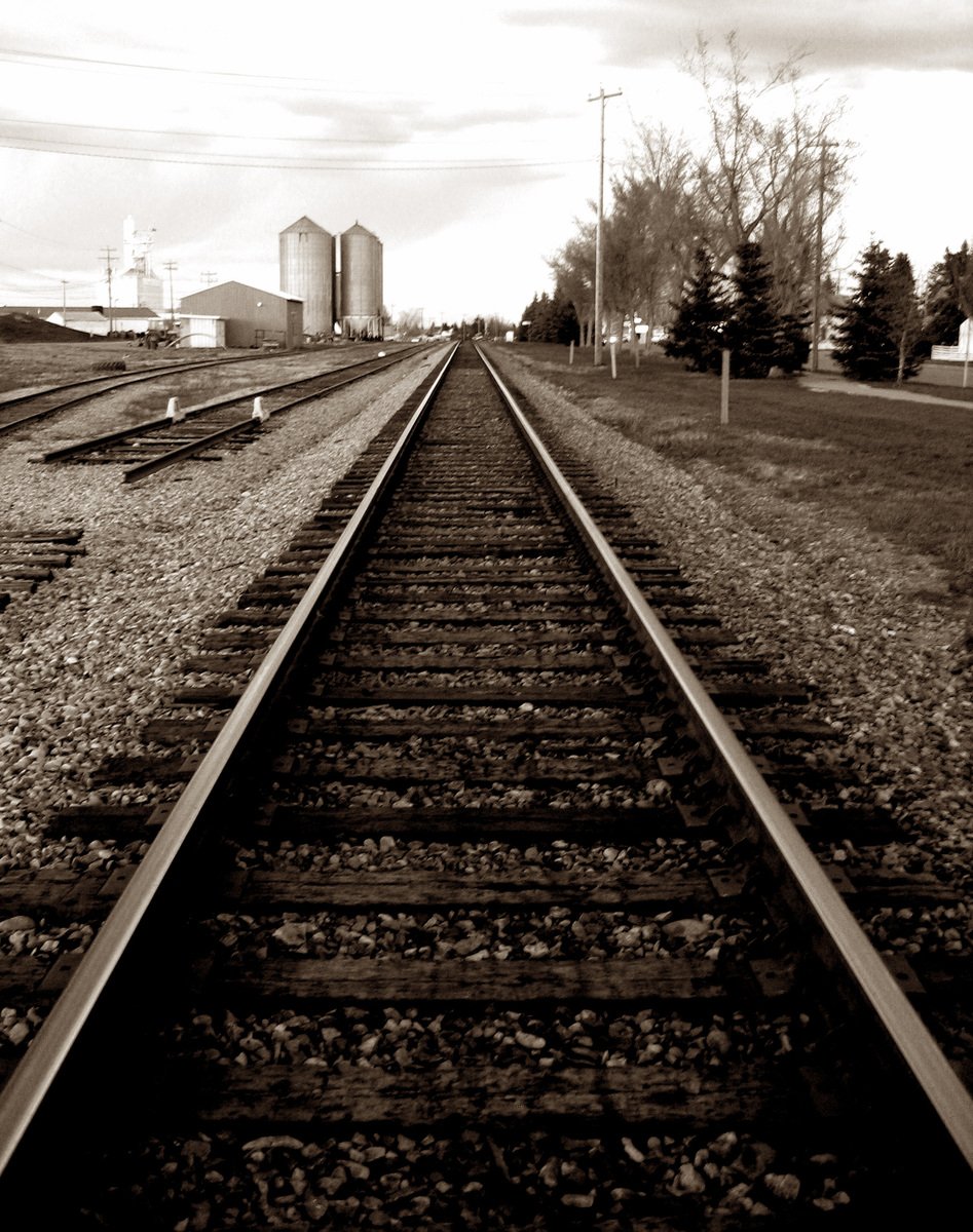 black and white picture of railroad tracks in the country