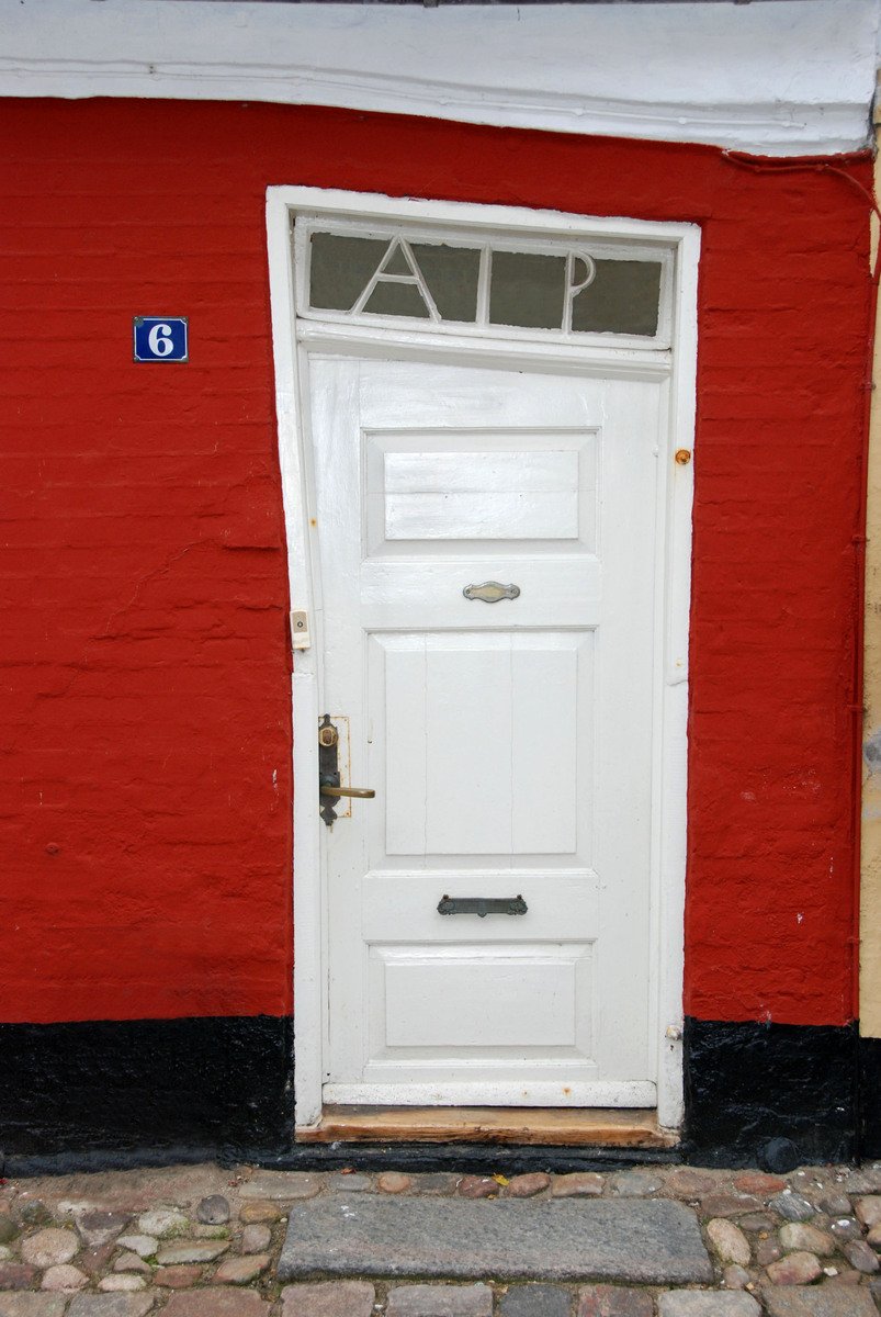 a doorway with a number is painted on the front of a red wall