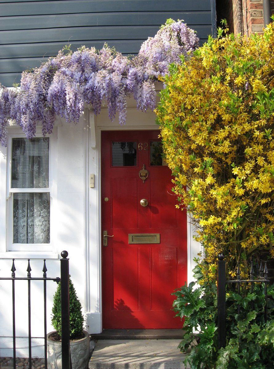 a doorway and a red front door in a house