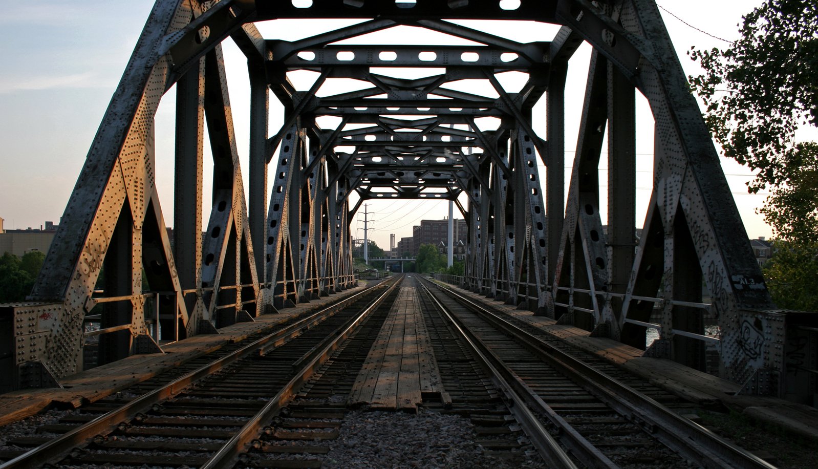 a train track that is near a tall bridge