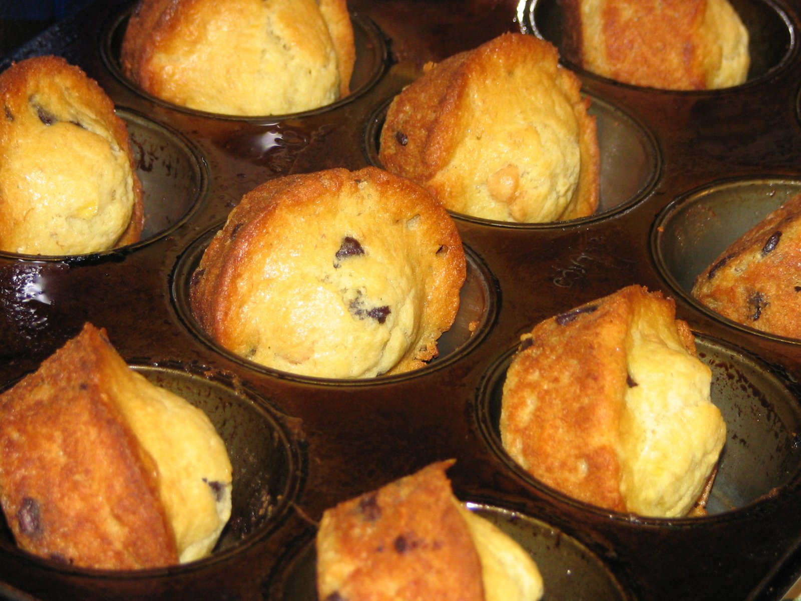 many cupcakes are sitting in tins on a table