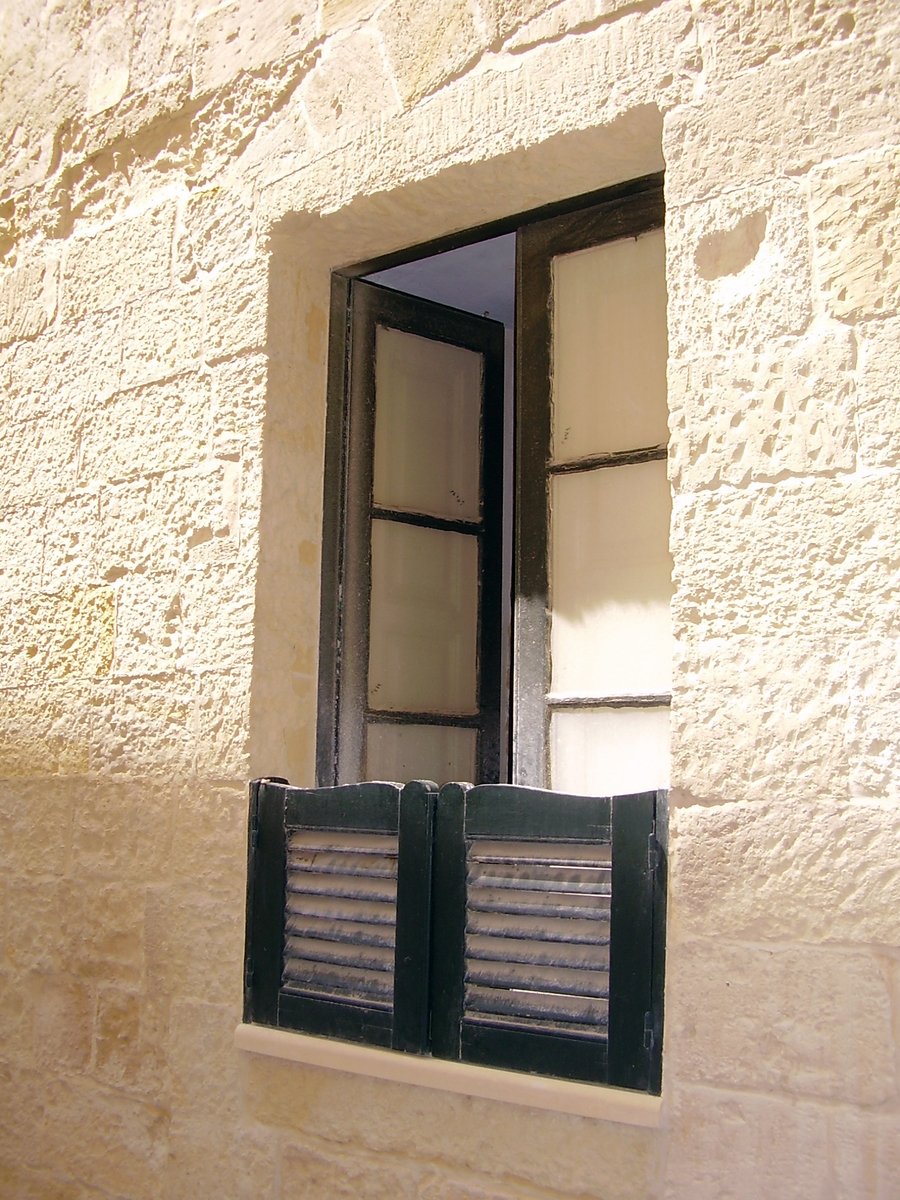 a window with blinds and bars on it