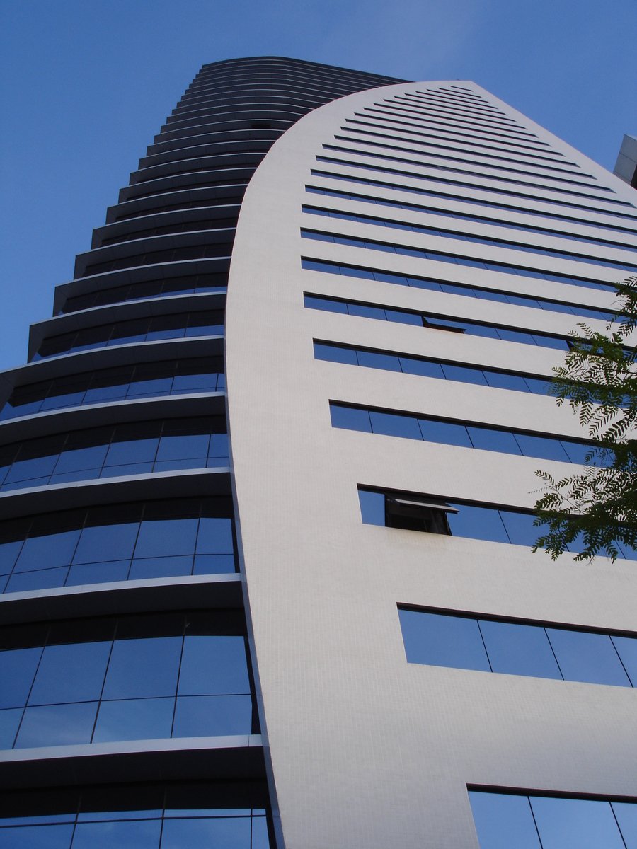 a tall white building on a sunny day