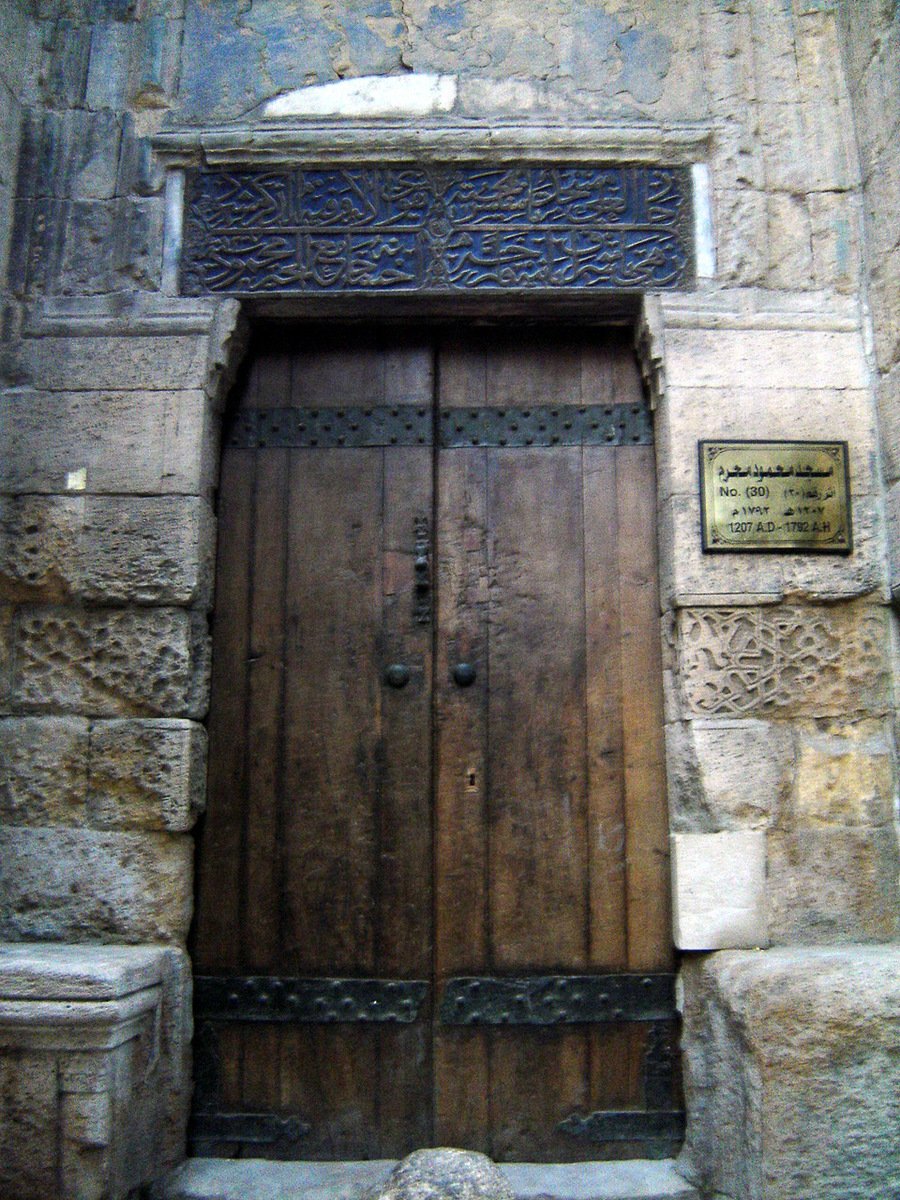 a picture of an old stone building with two doors