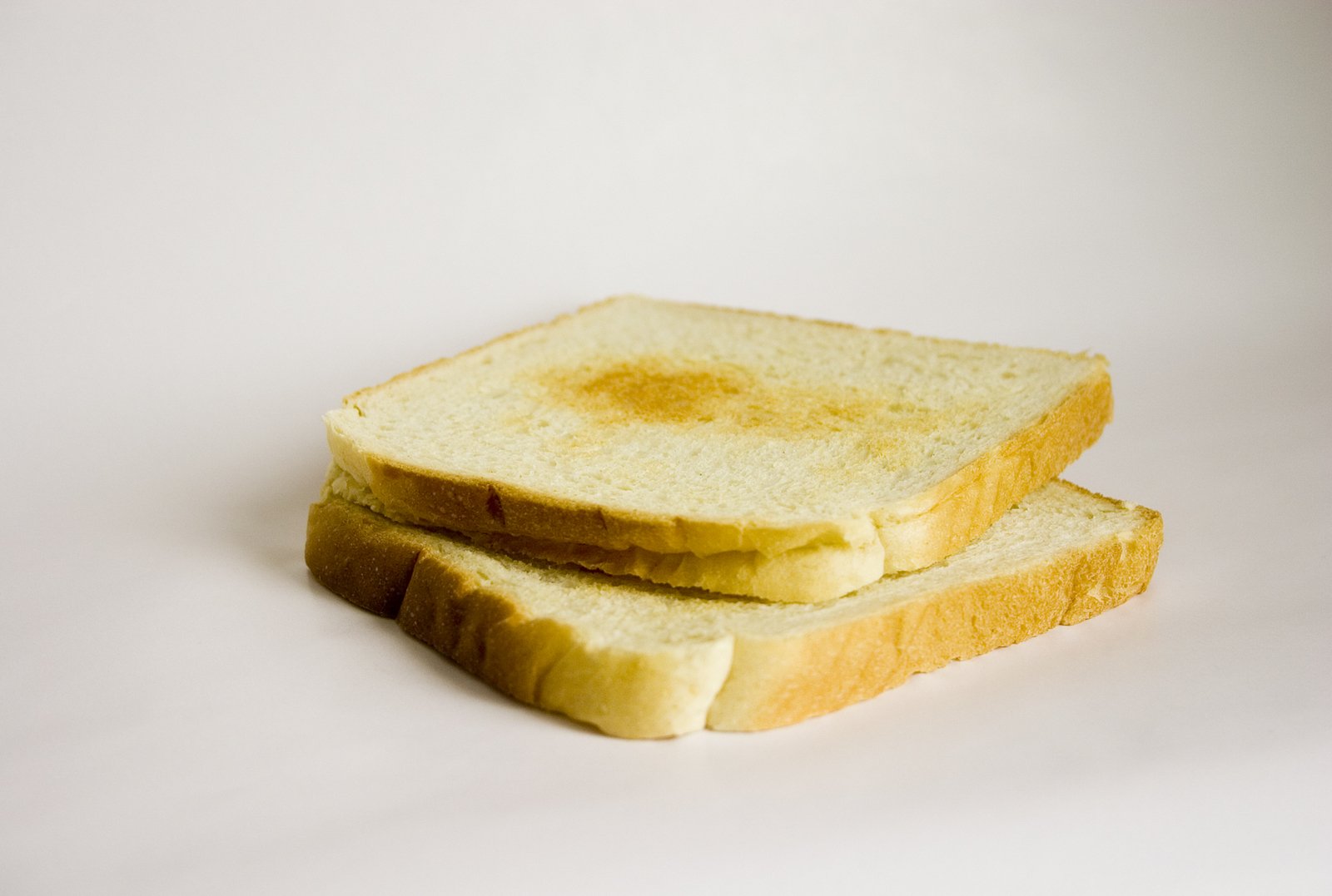 two slices of bread on a white surface