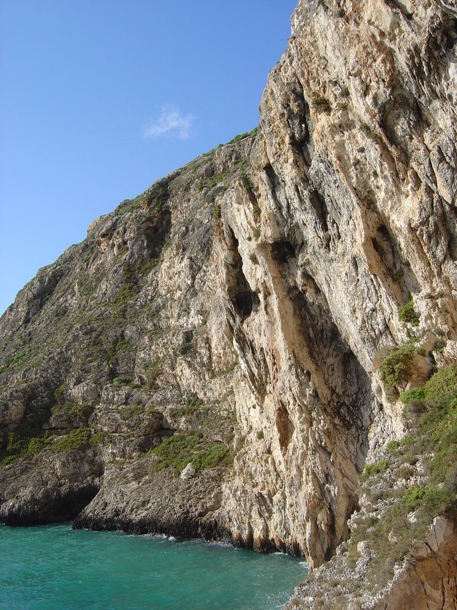 a cliff and body of water next to each other