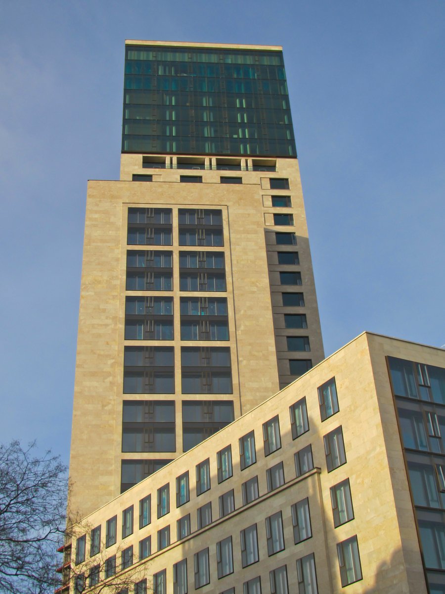 a high rise building with windows is in the sky