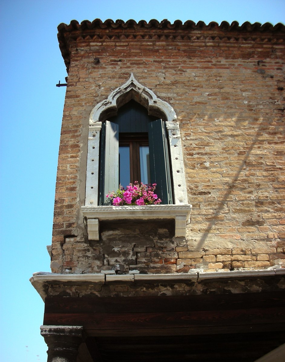 a window on the outside of an old building