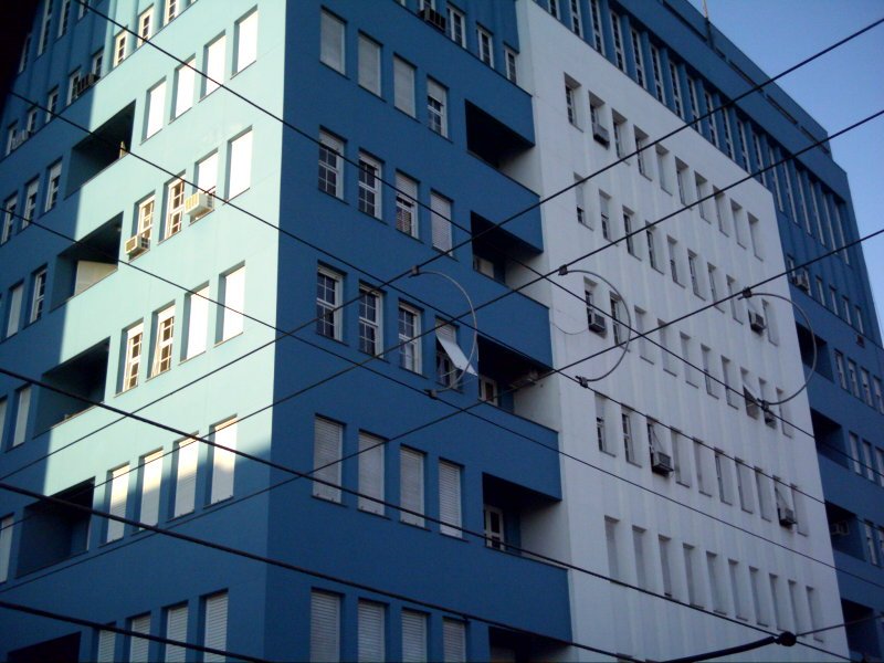 the building next to the telephone wires has many windows