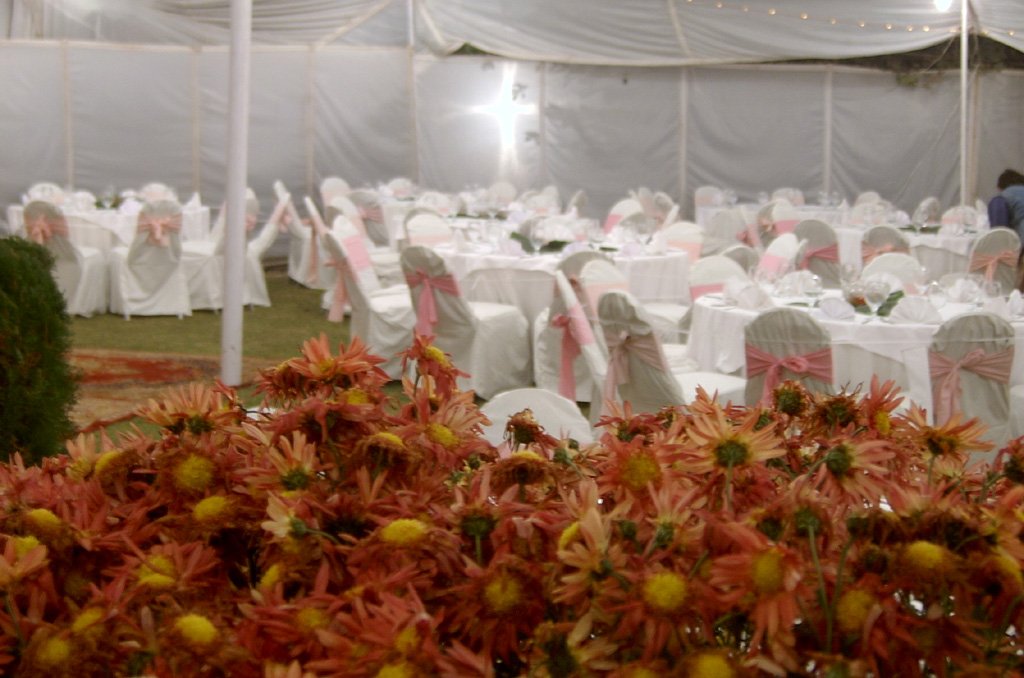 an event is set up inside with many tables and chairs covered with white tablecloths