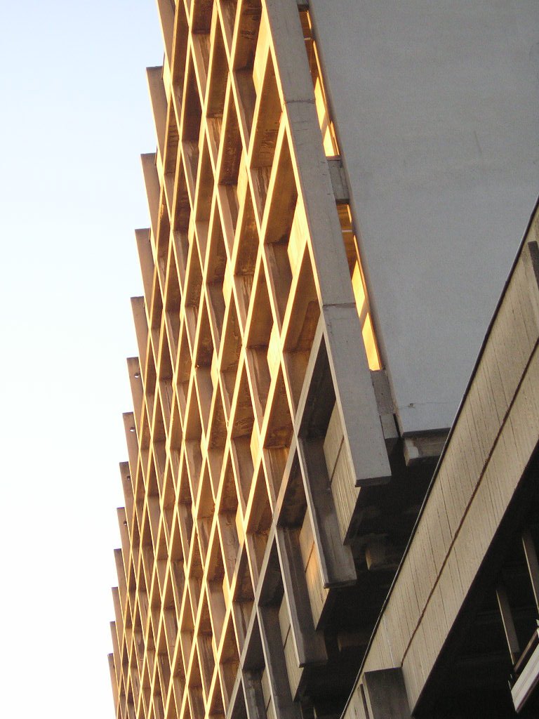 a very tall brown building on a clear day