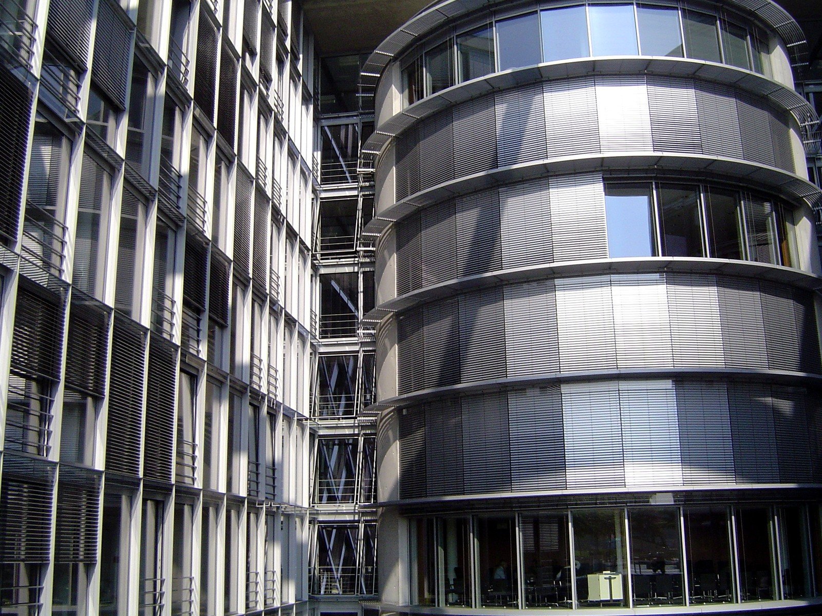 a modern building with a spiral staircase made from stainless tubes