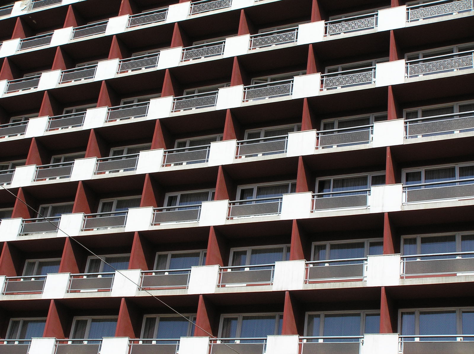 red and white building with lots of windows and balconies