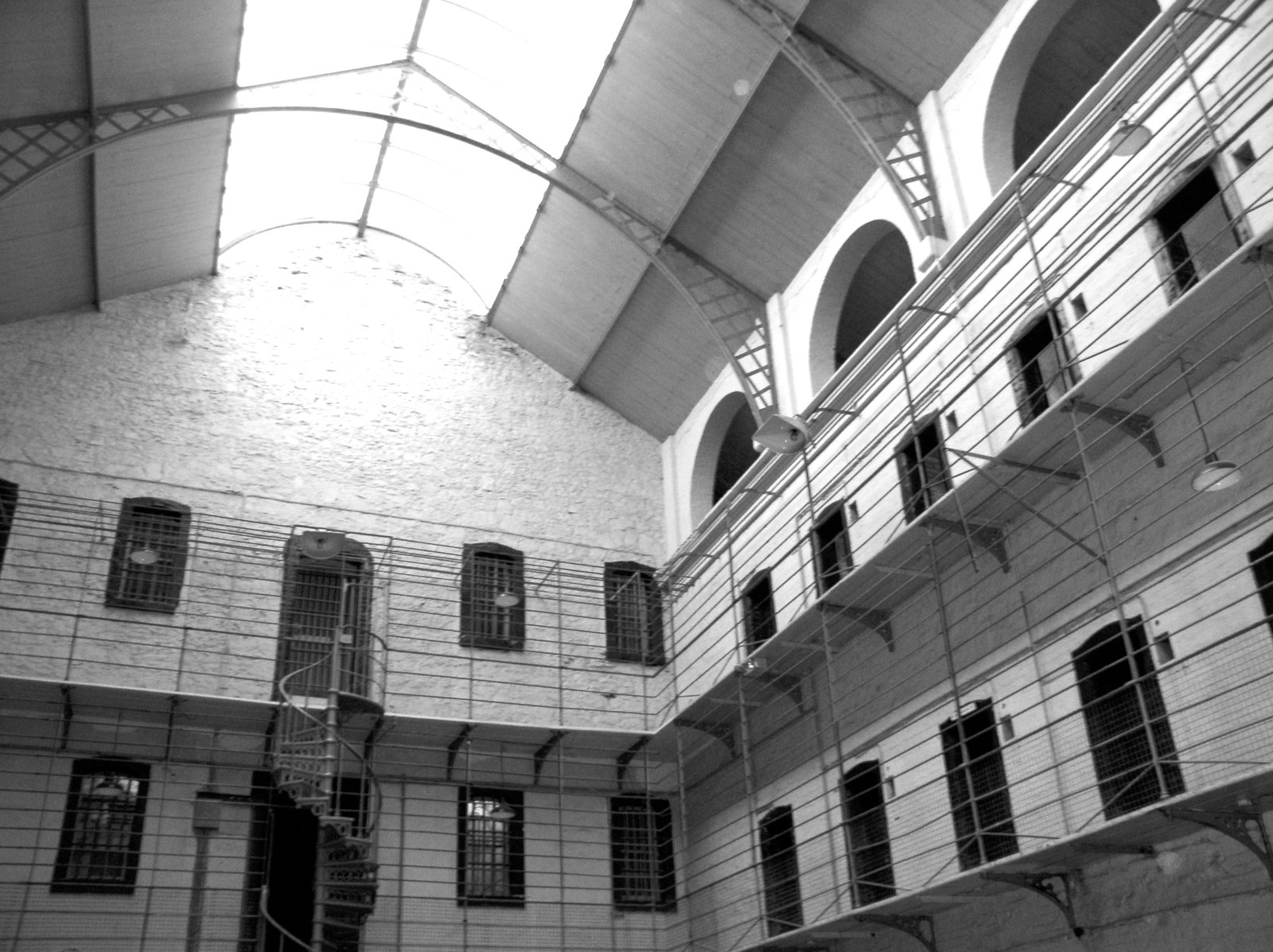 a courtyard with an interesting roof and barred windows