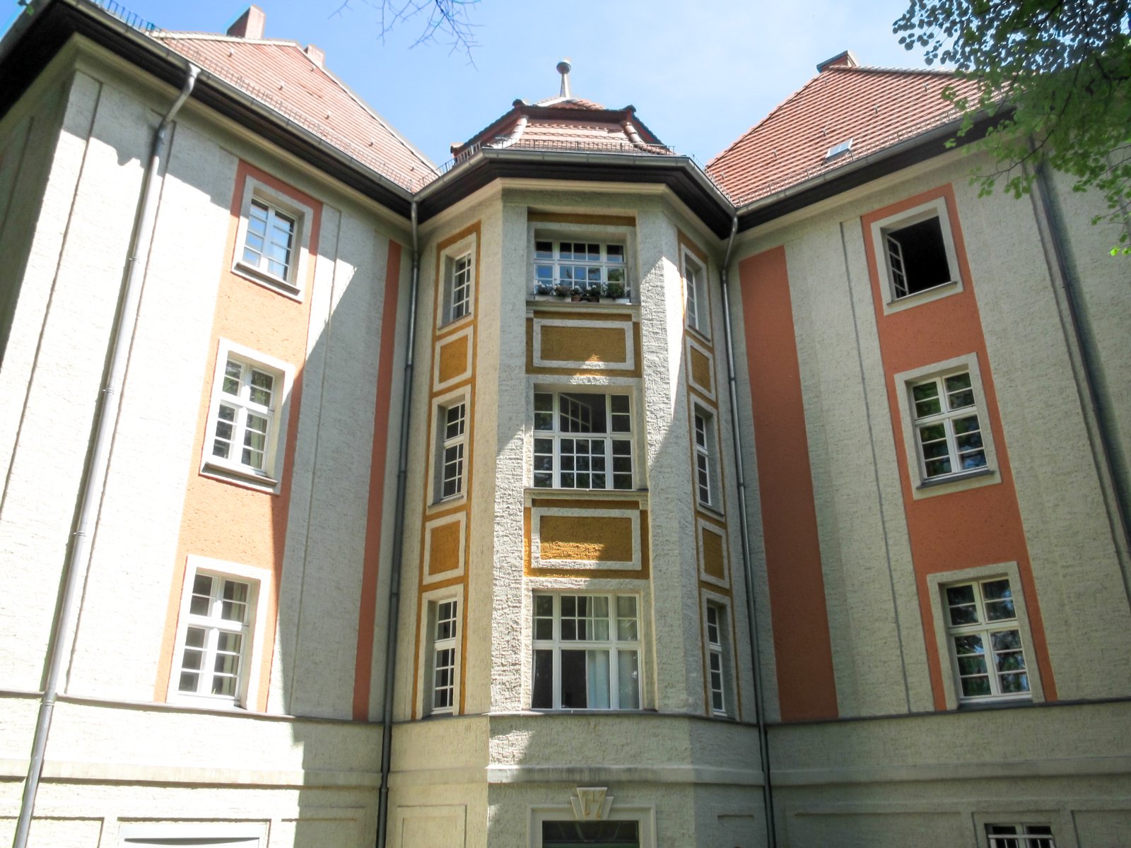 a building with red and tan trim is shown