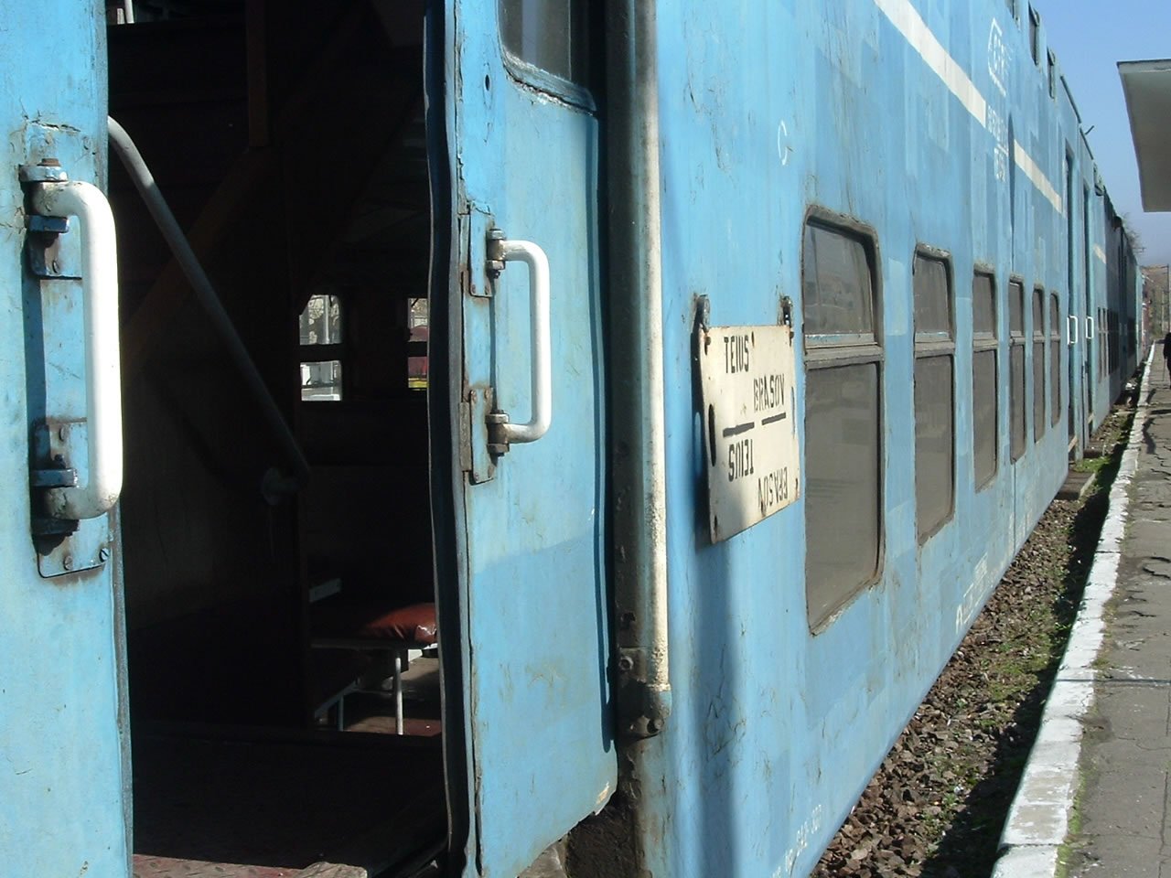 a train is blue with signs on the door