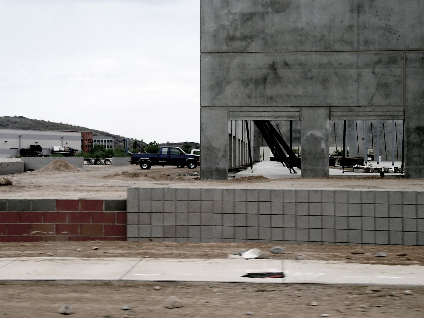 a truck and a building on a dirt area