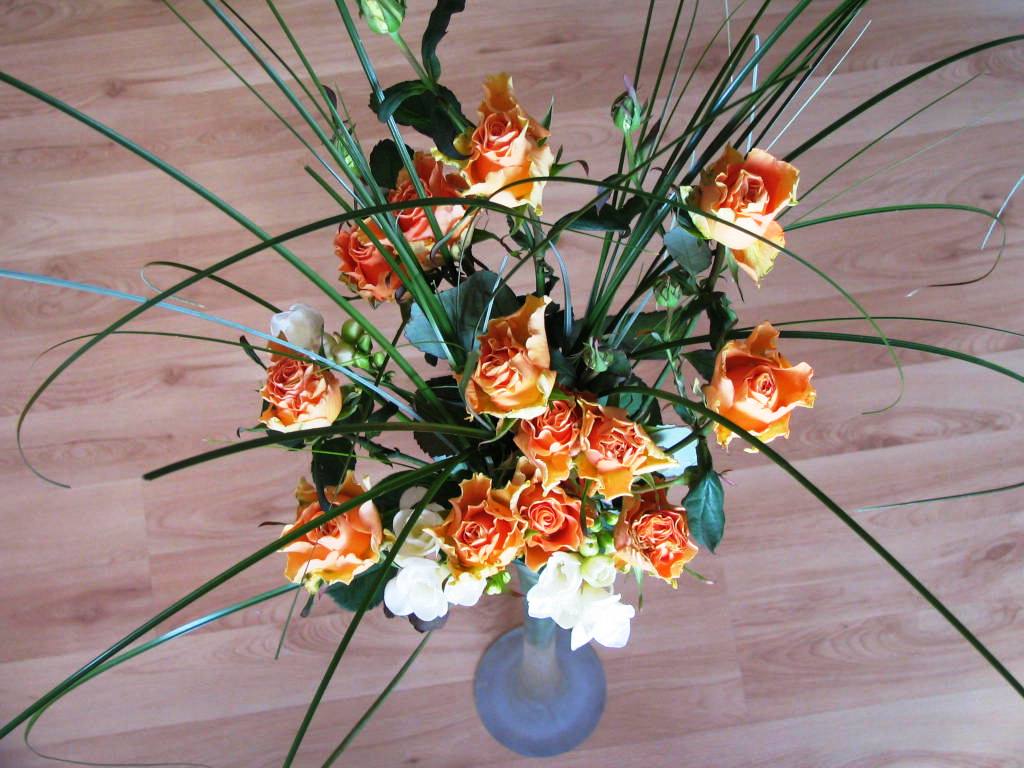 a blue vase filled with orange and white flowers
