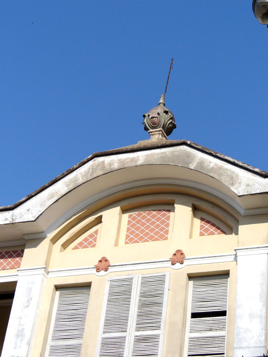 a building with two birds sitting on top of it