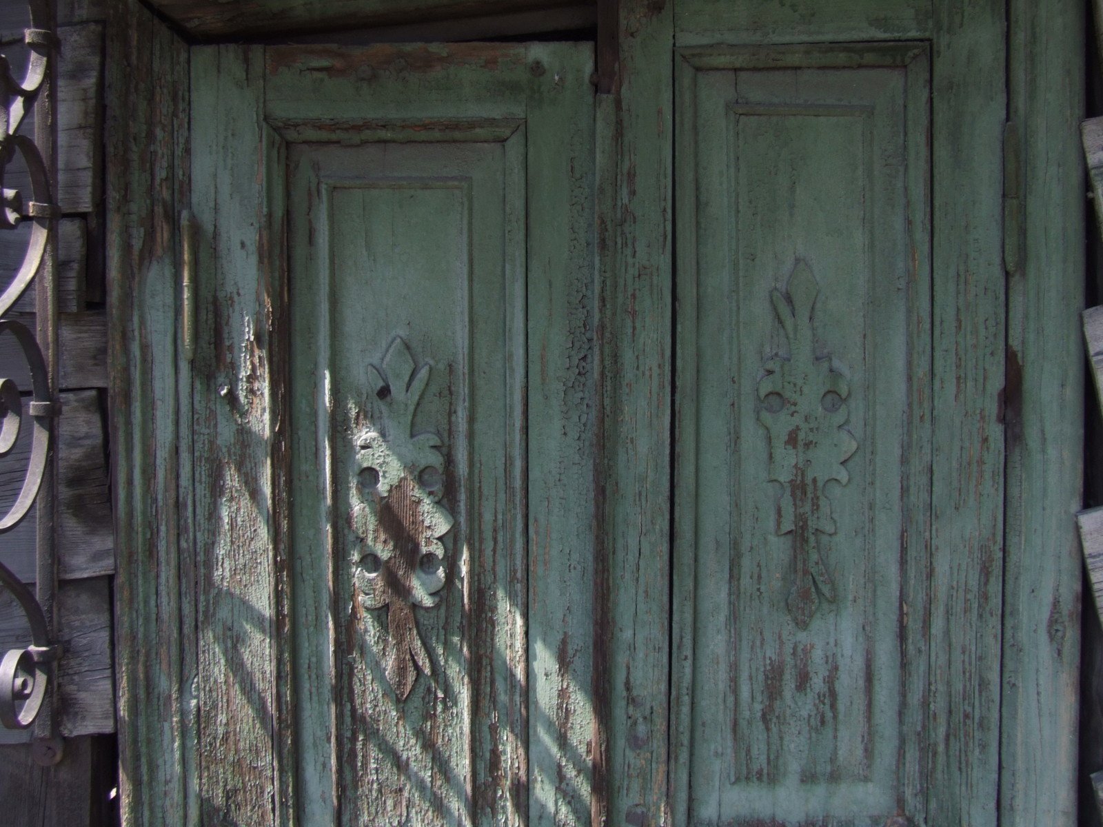 the old wood door is painted green