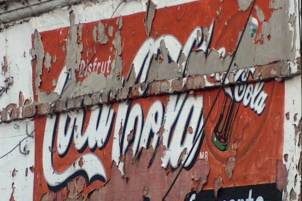 an old faded and painted sign with the word war on it