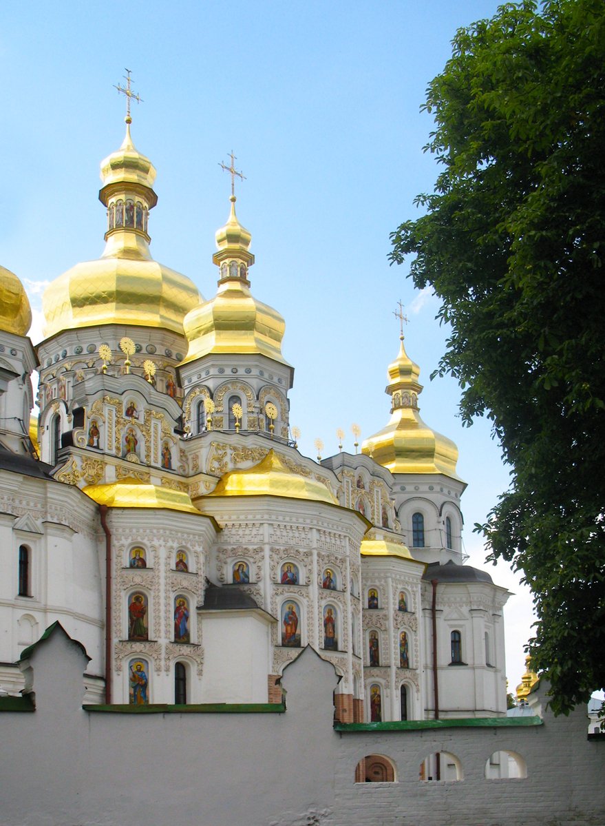 a large white building with yellow domes