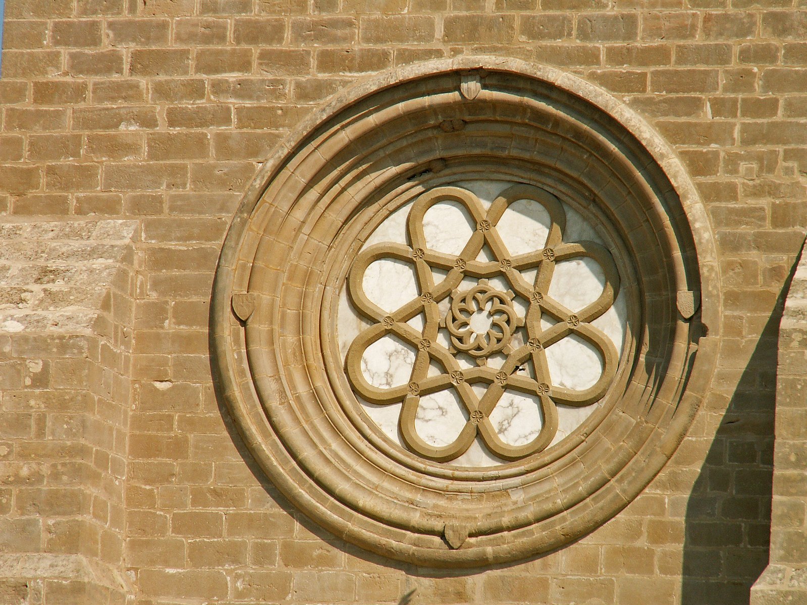 a circular window with a decorative flower at the center