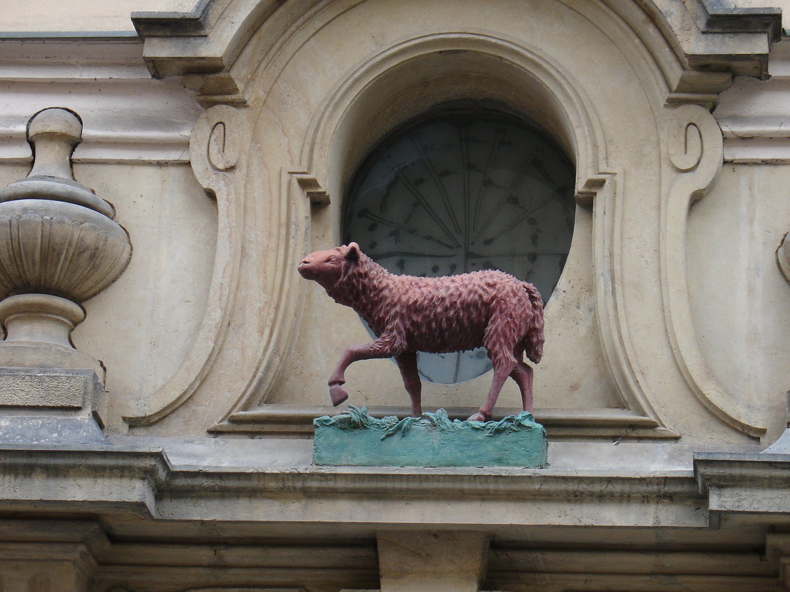 an animal sculpture stands on a small stone display