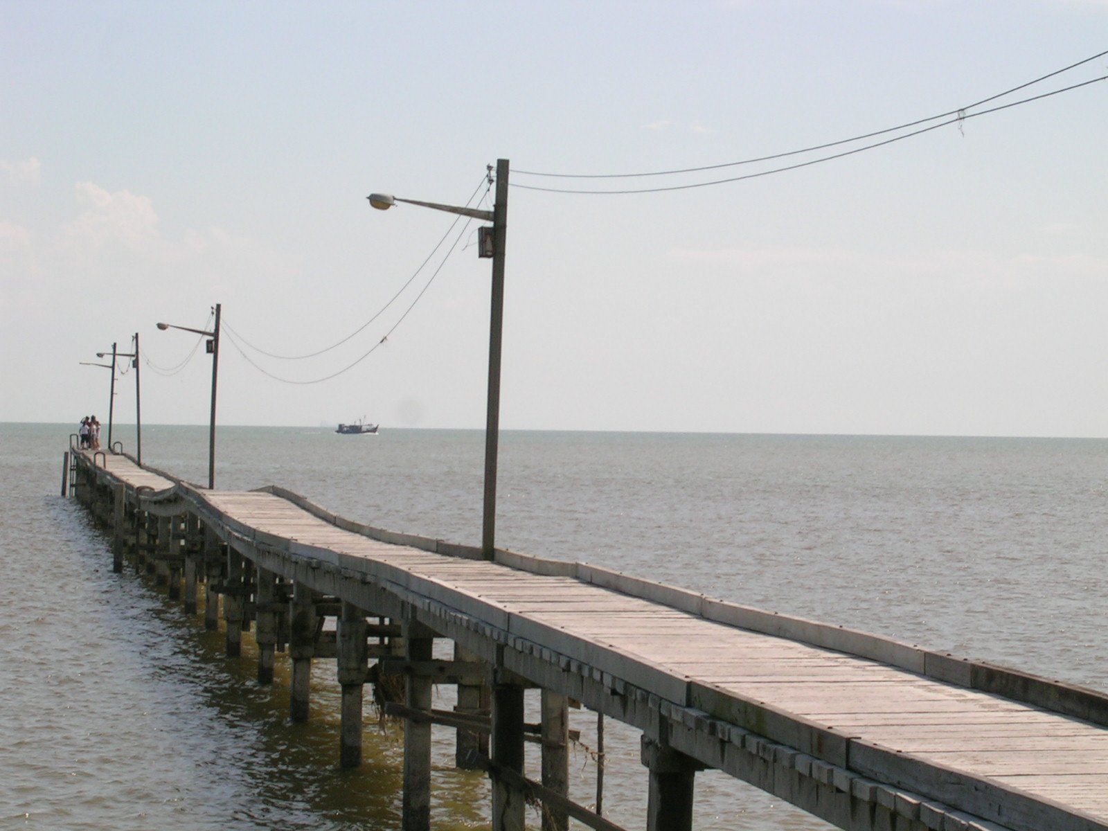 there is a boardwalk by the water that is empty