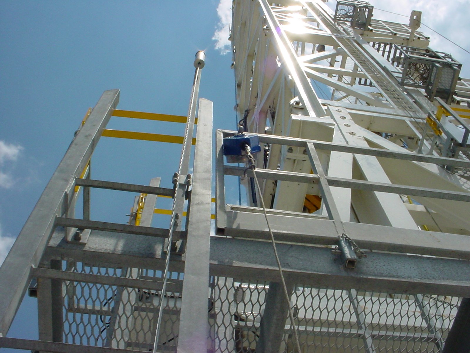 a fire truck ladder and safety railings near the top of a building