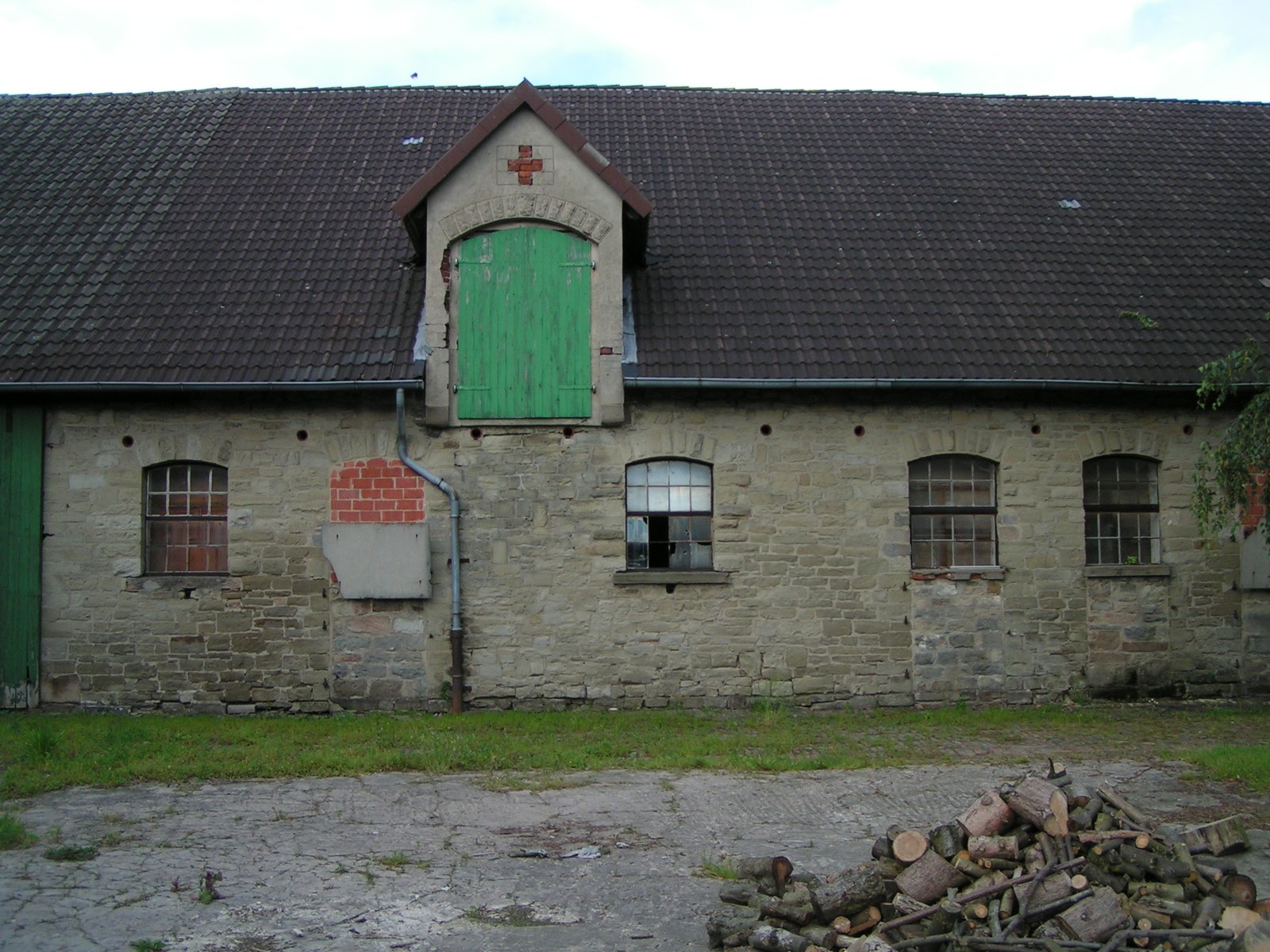 an old church with a green door and windows