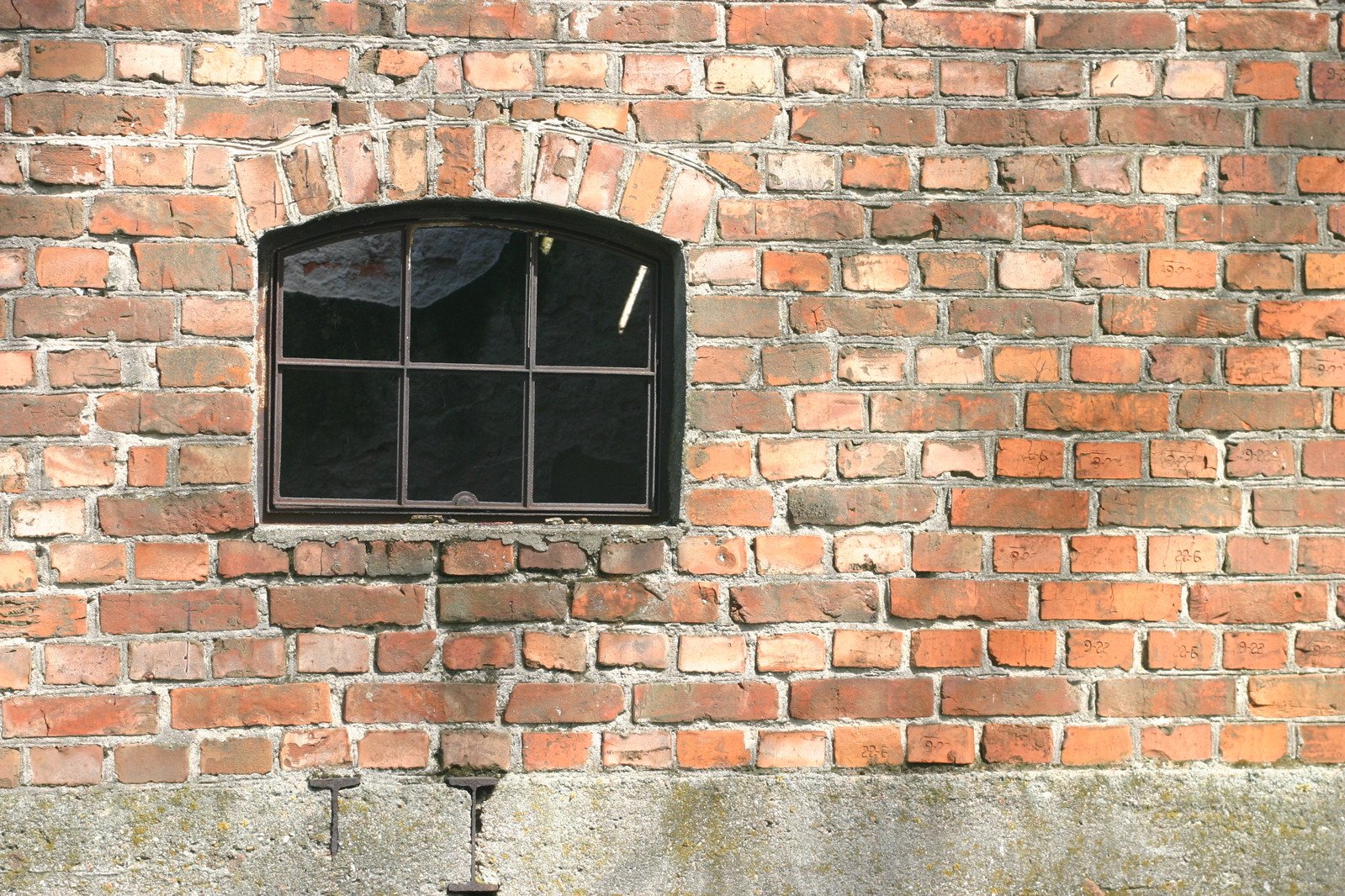 an old brick building with a small window