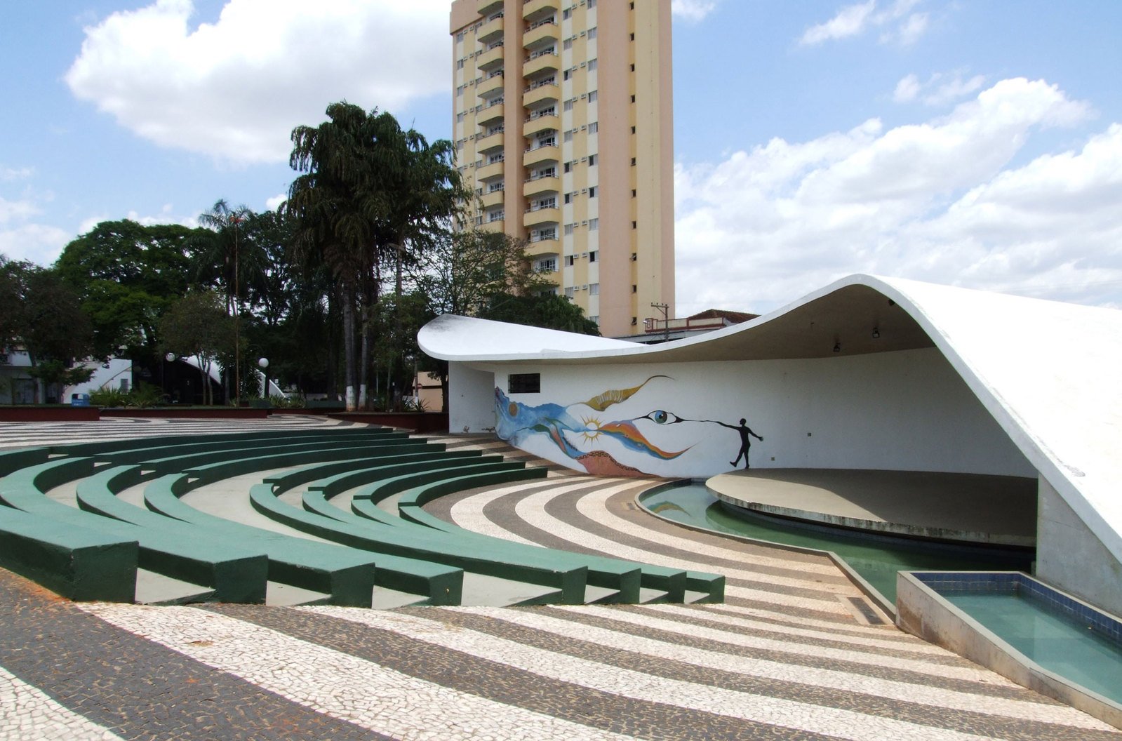 a building with stairs in the front and a large wall in back